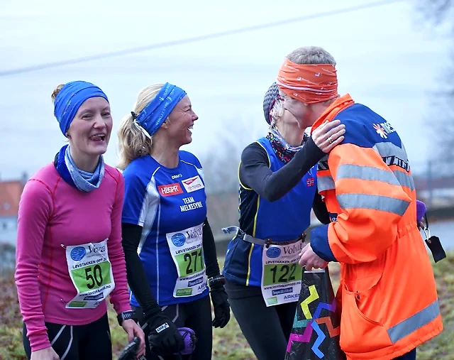 Runners in Andersen's Advent Race smile and congratulate each other.
