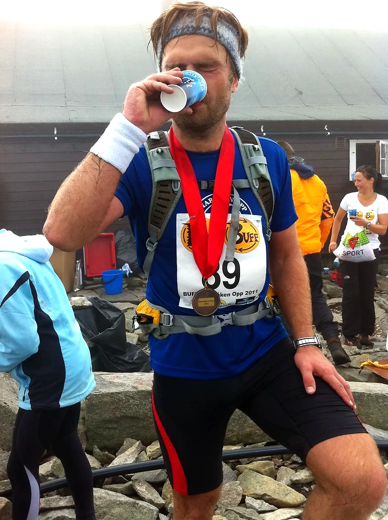 Runner after Bronane Up drinks, medal, and bib number visible.