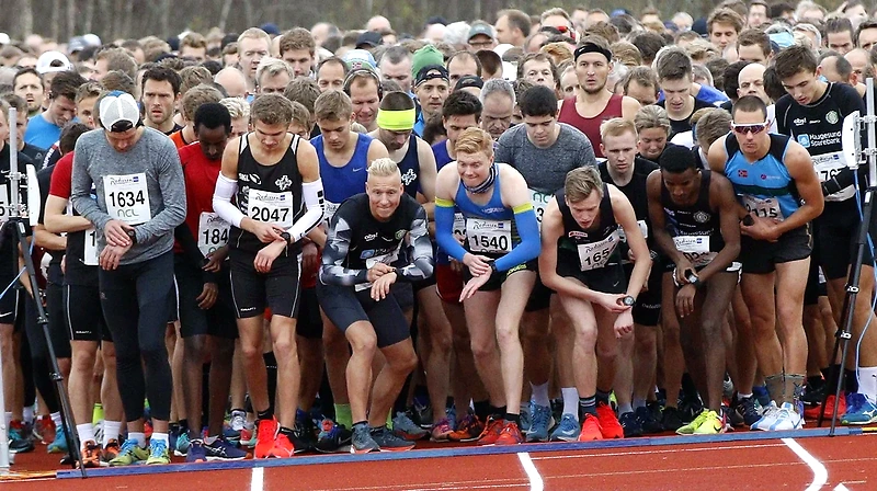 Runners ready at the starting line for a cross-country race.