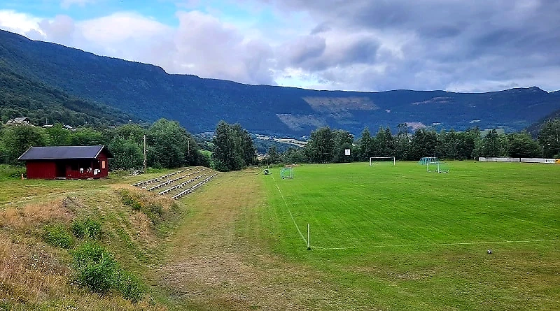 View over a sports field and mountains.