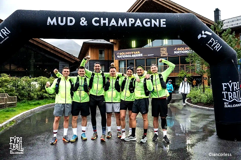 Runners under the Fýri Trail arch after the race, with Salomon logos.
