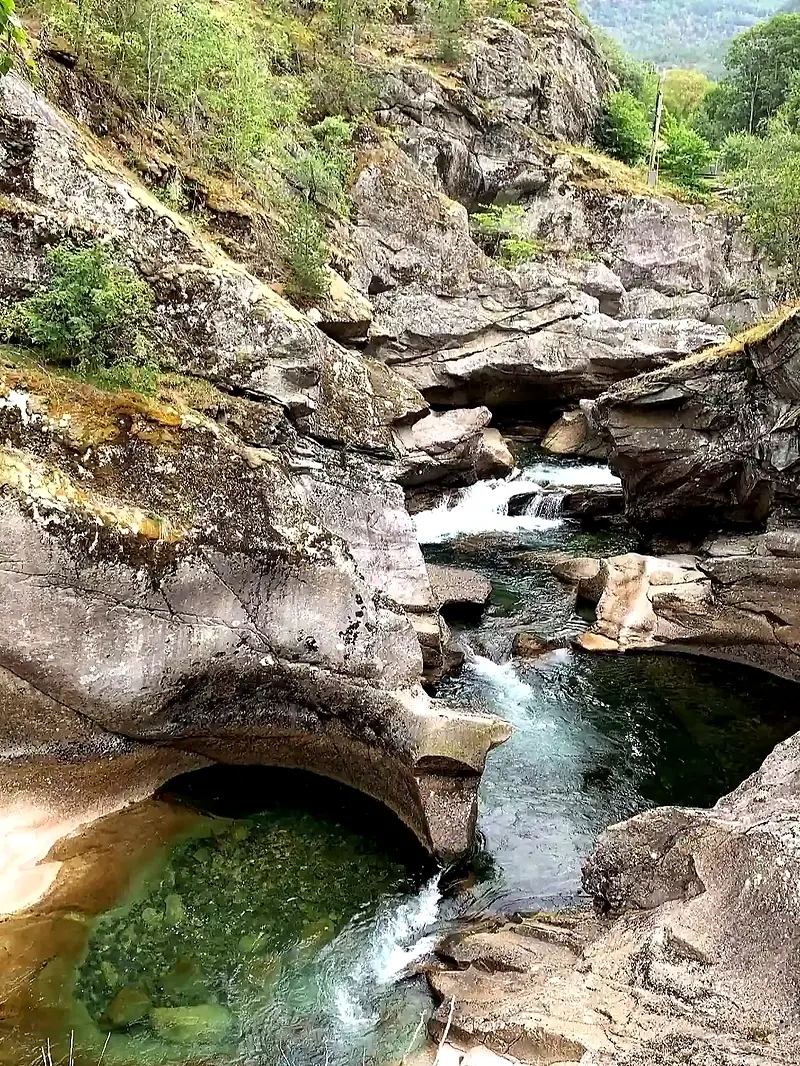 River flowing through rocky landscape. Green water and cliffs.
