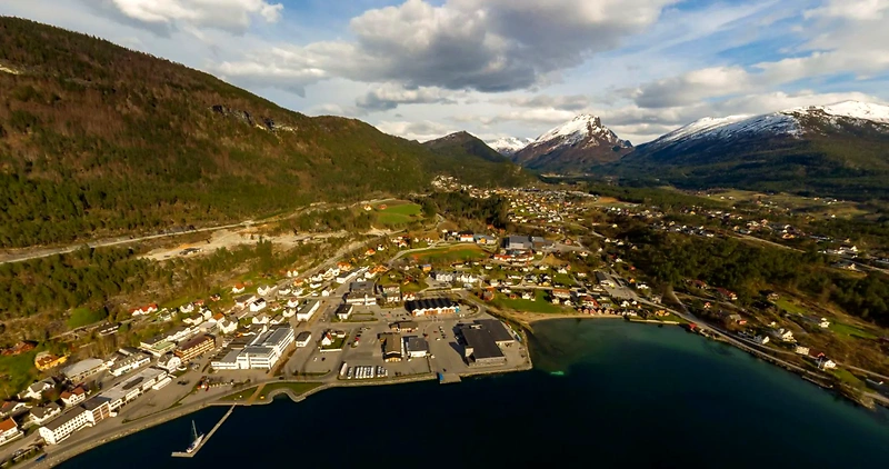 Aerial photo of Sandane, Gloppen, with mountains and fjord.