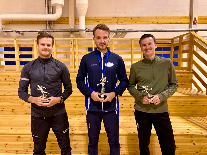 Three men with trophies. Potential award ceremony from a race.
