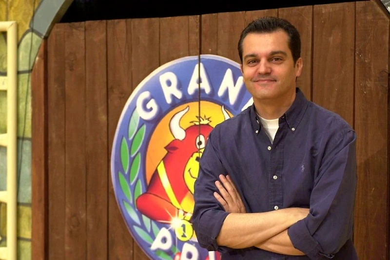 Man in front of Grand Prix logo.
