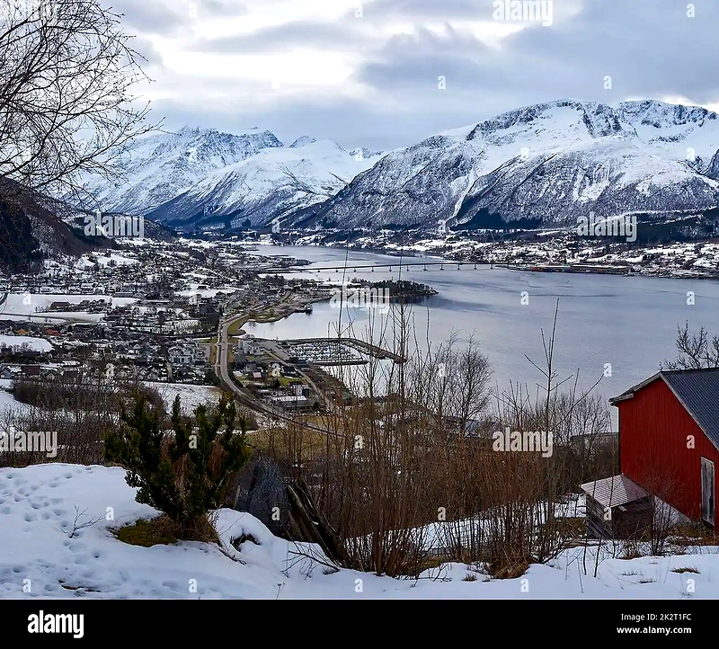 Beautiful landscape with mountains, water, and a city, likely the location of the race.