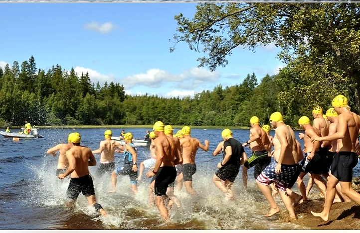 Participants in the Byaloppet swim out of the water.