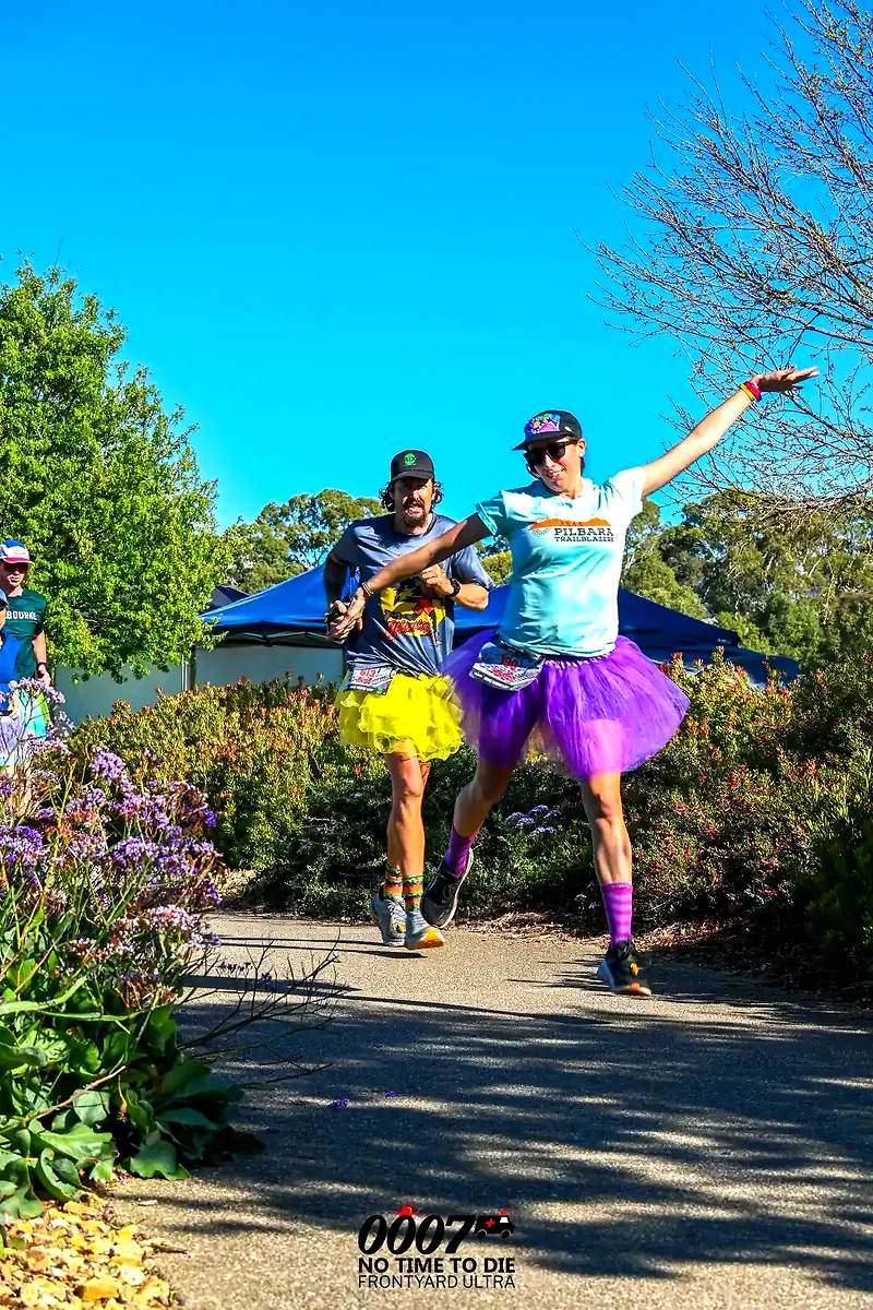 Runners in colorful skirts during a sunny race, Frontyard Rudan.