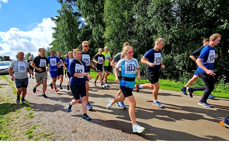 Deltagare springer i ett trailrace i vacker natur.