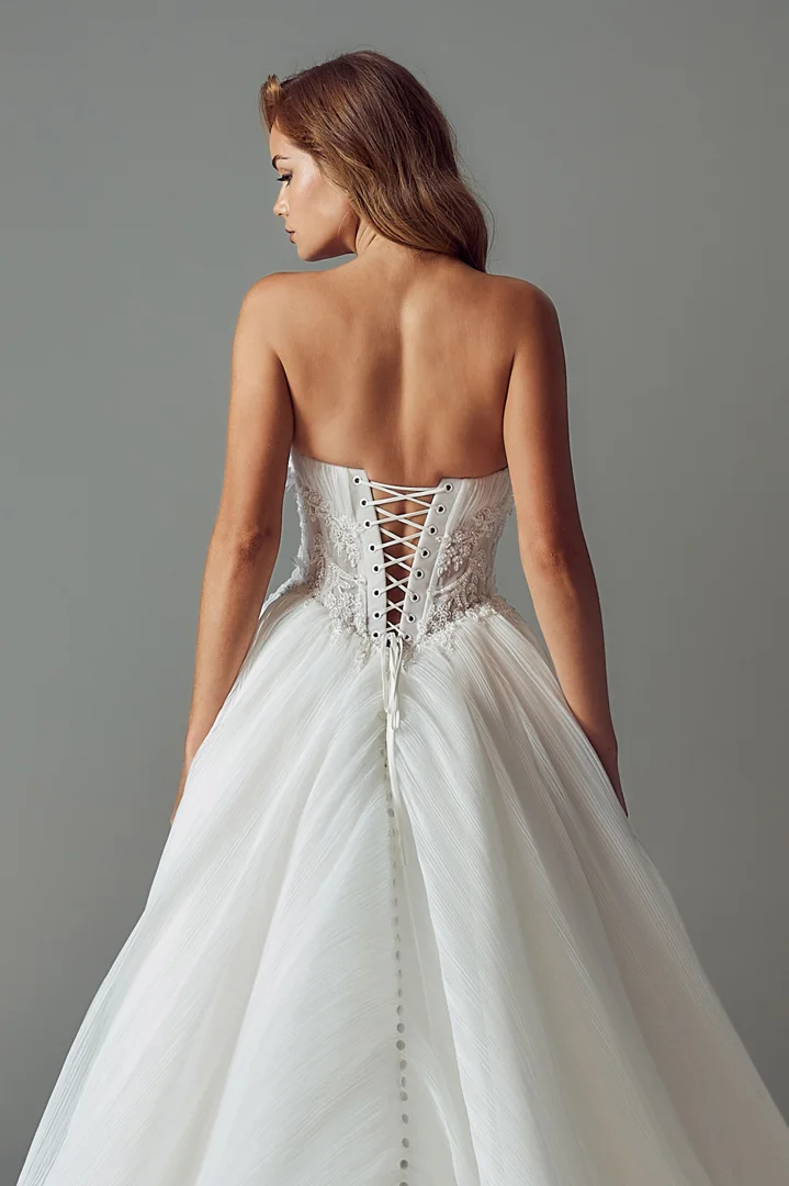 Hand-lacing detail on an ivory bridal corset back with ribbon