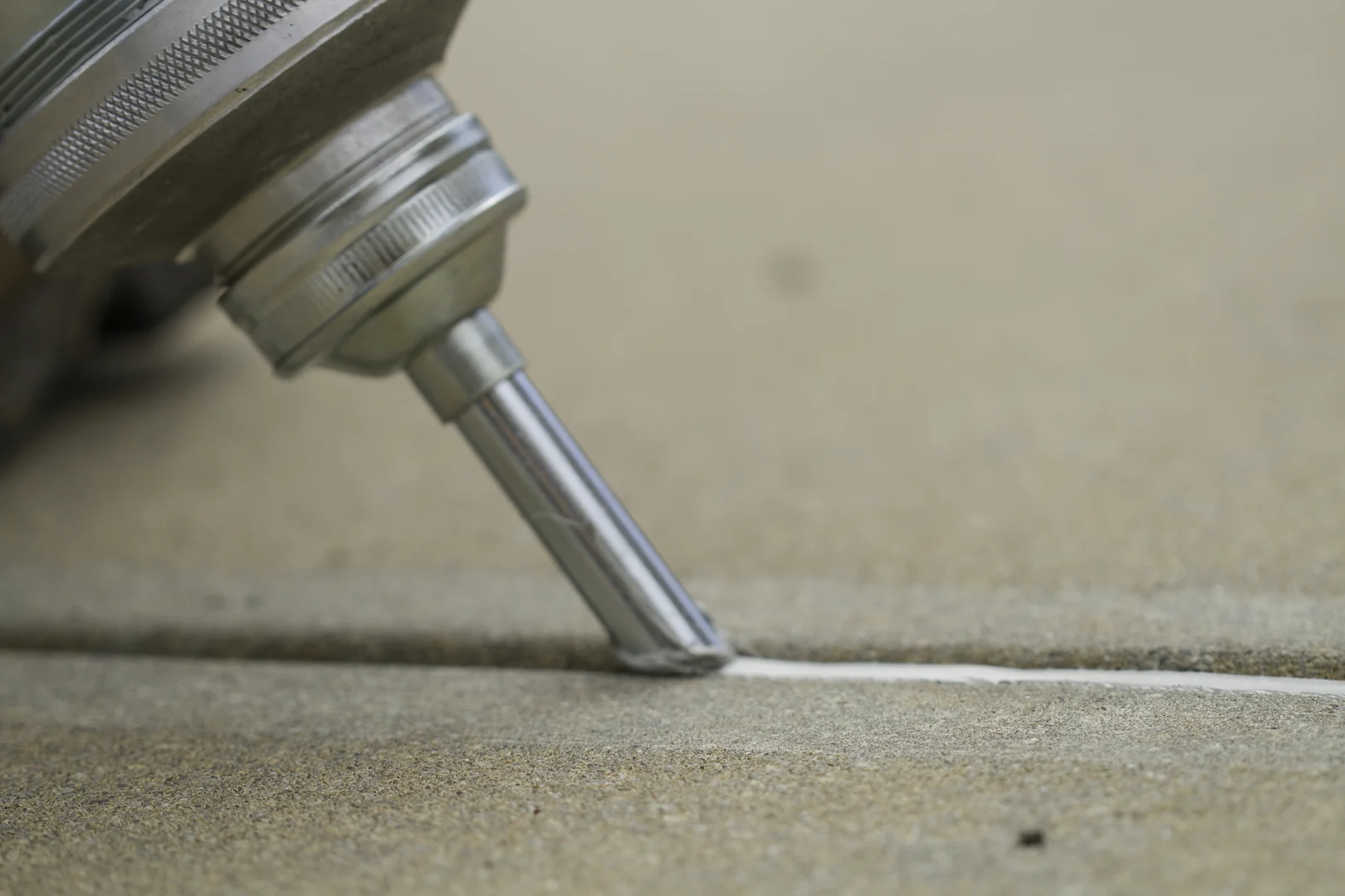 Professional application of concrete joint sealant on an exterior expansion joint Professional application of concrete joint sealant on an exterior expansion joint