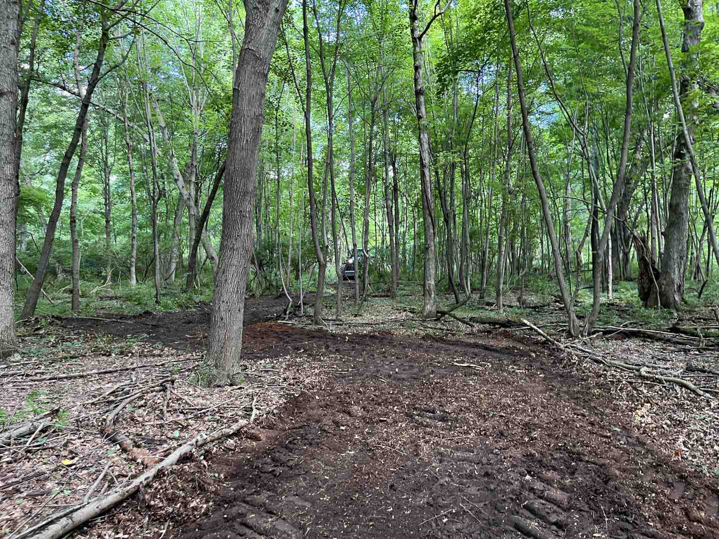professional using clinometer - trail building and maintenance