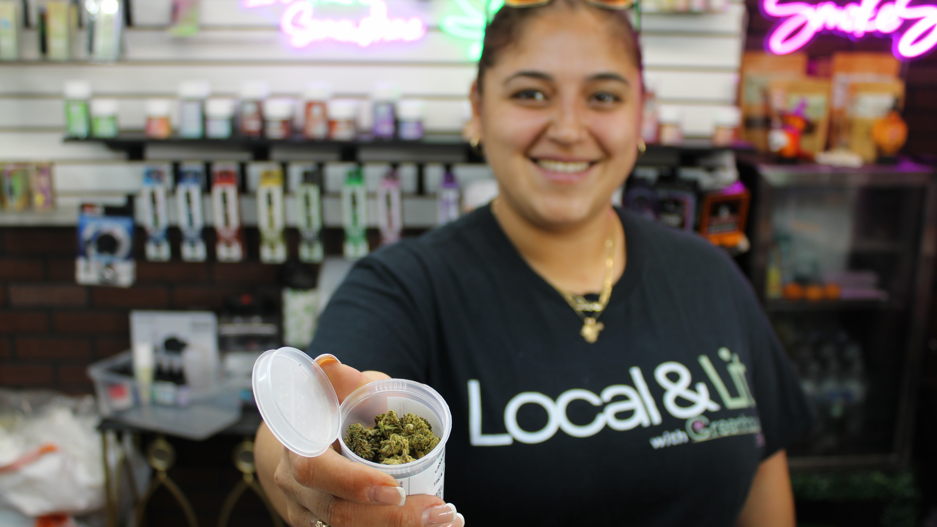Person looking at a THC cart package in a dispensary setting - thc cart