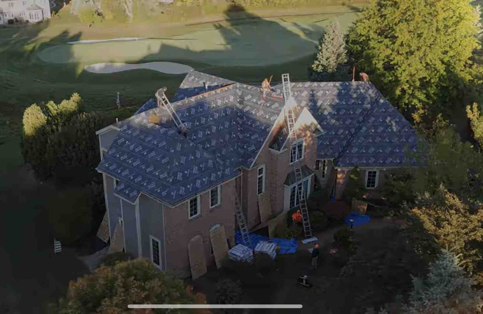 A professional roofing technician conducting a detailed roof inspection on a Rochester home A professional roofing technician conducting a detailed roof inspection on a Rochester home