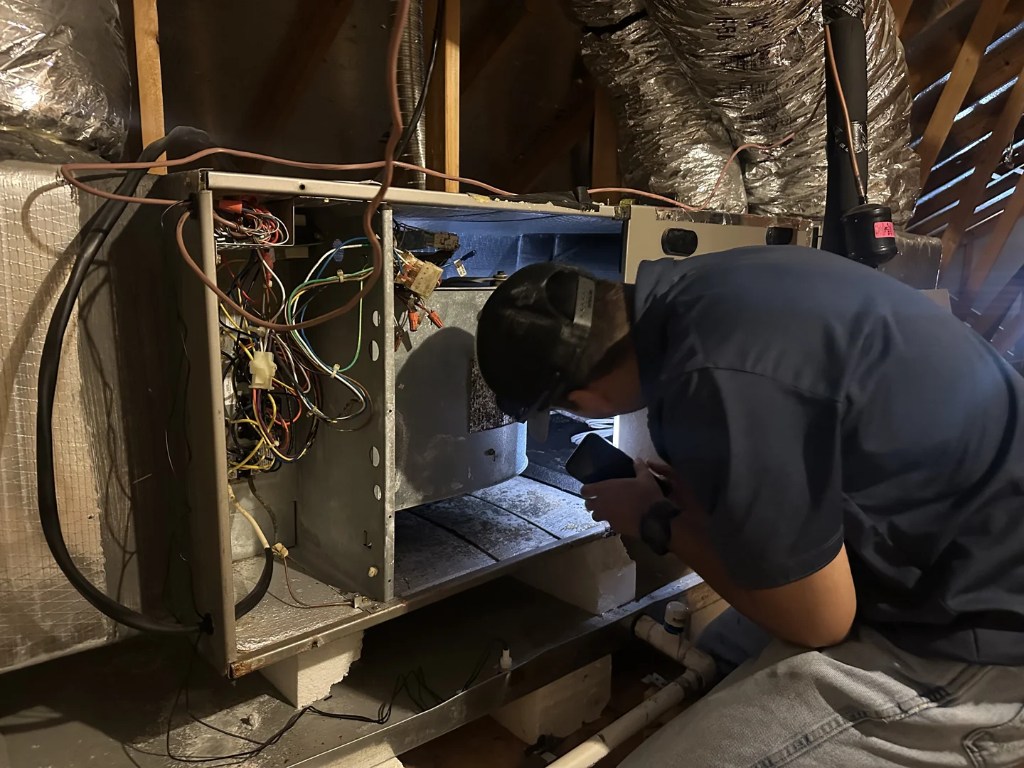 professional technician inspecting residential ductwork