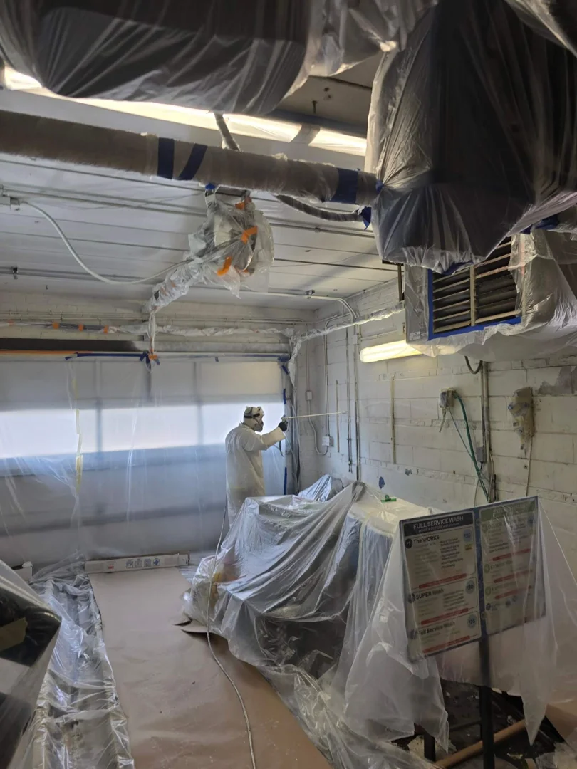 Industrial metal surface preparation showing sandblasting prior to commercial spray painting Industrial metal surface preparation showing sandblasting prior to commercial spray painting