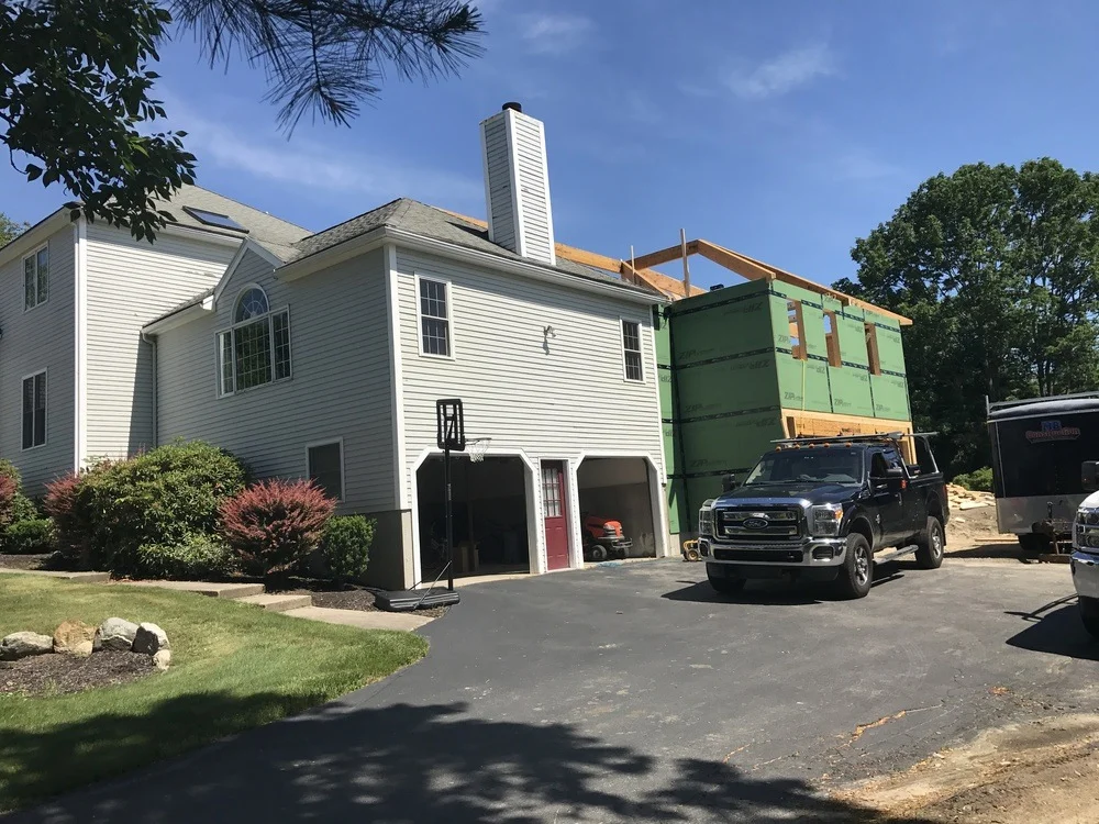 Residential construction site showing the framing of a new home addition - cost of 300 sq ft addition