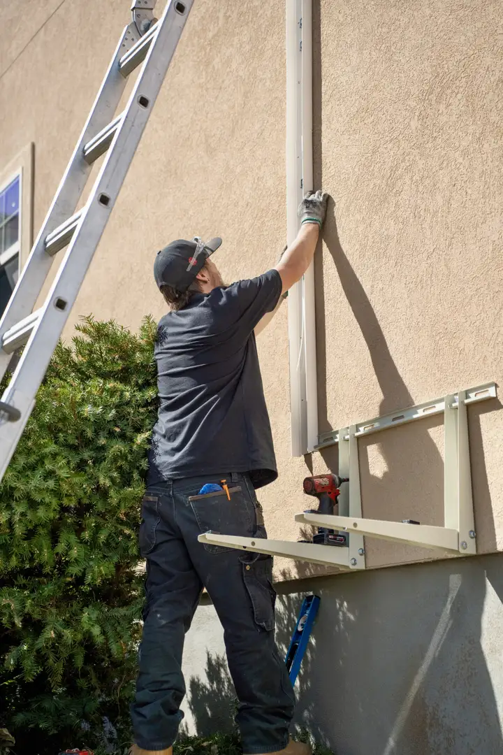 certified technicians installing an outdoor cooling unit