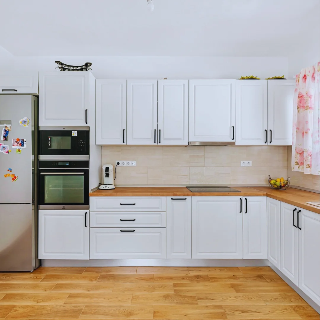 Modern kitchen refresh in a Doncaster East townhouse showing new benchtops and lighting - cosmetic renovations