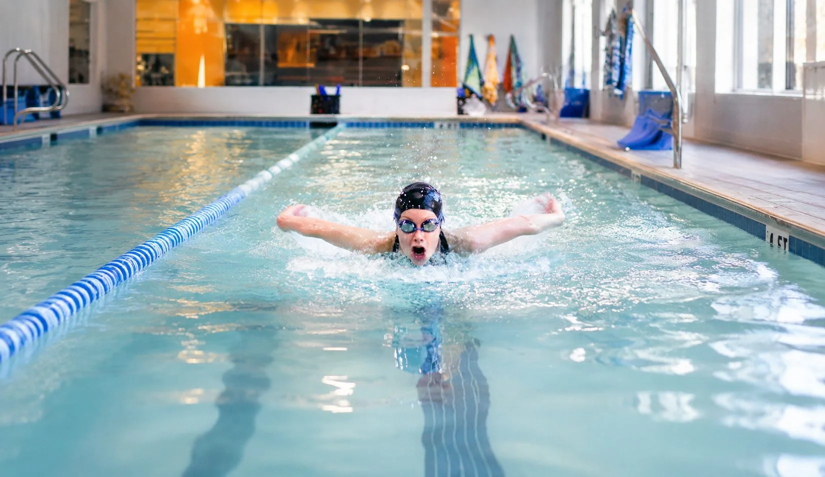 Swimmer practicing breaststroke kick and arm coordination Swimmer practicing breaststroke kick and arm coordination