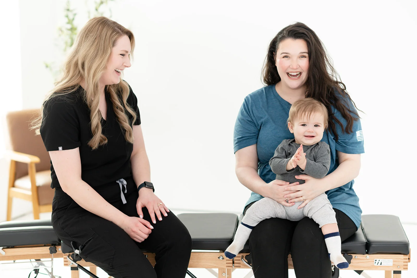 chiropractor talking warmly with a mother and infant - Chiropractic Care for Ear Infections in Babies: What Parents Should
