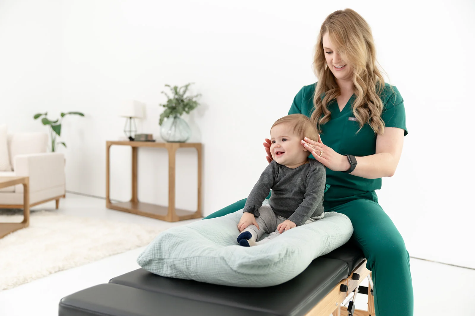 chiropractor performing a gentle pediatric adjustment on an infant - Chiropractic Care for Ear Infections in Babies: What