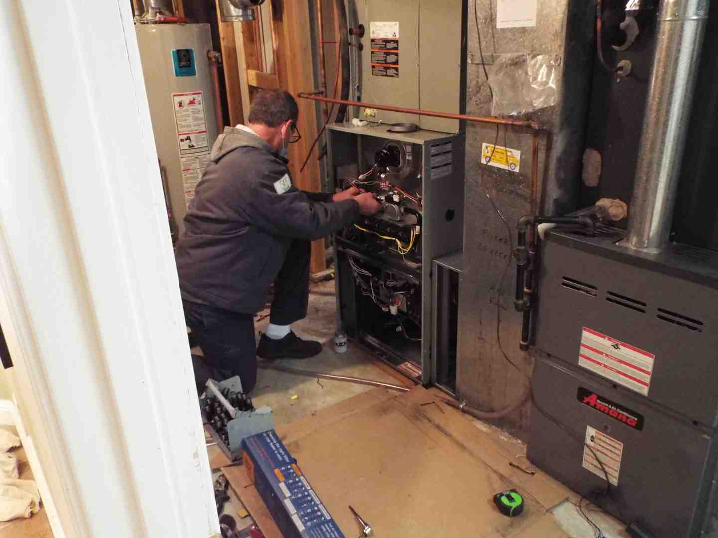 close up of a furnace's internal components, highlighting the flame sensor and wiring - furnace keeps stopping
