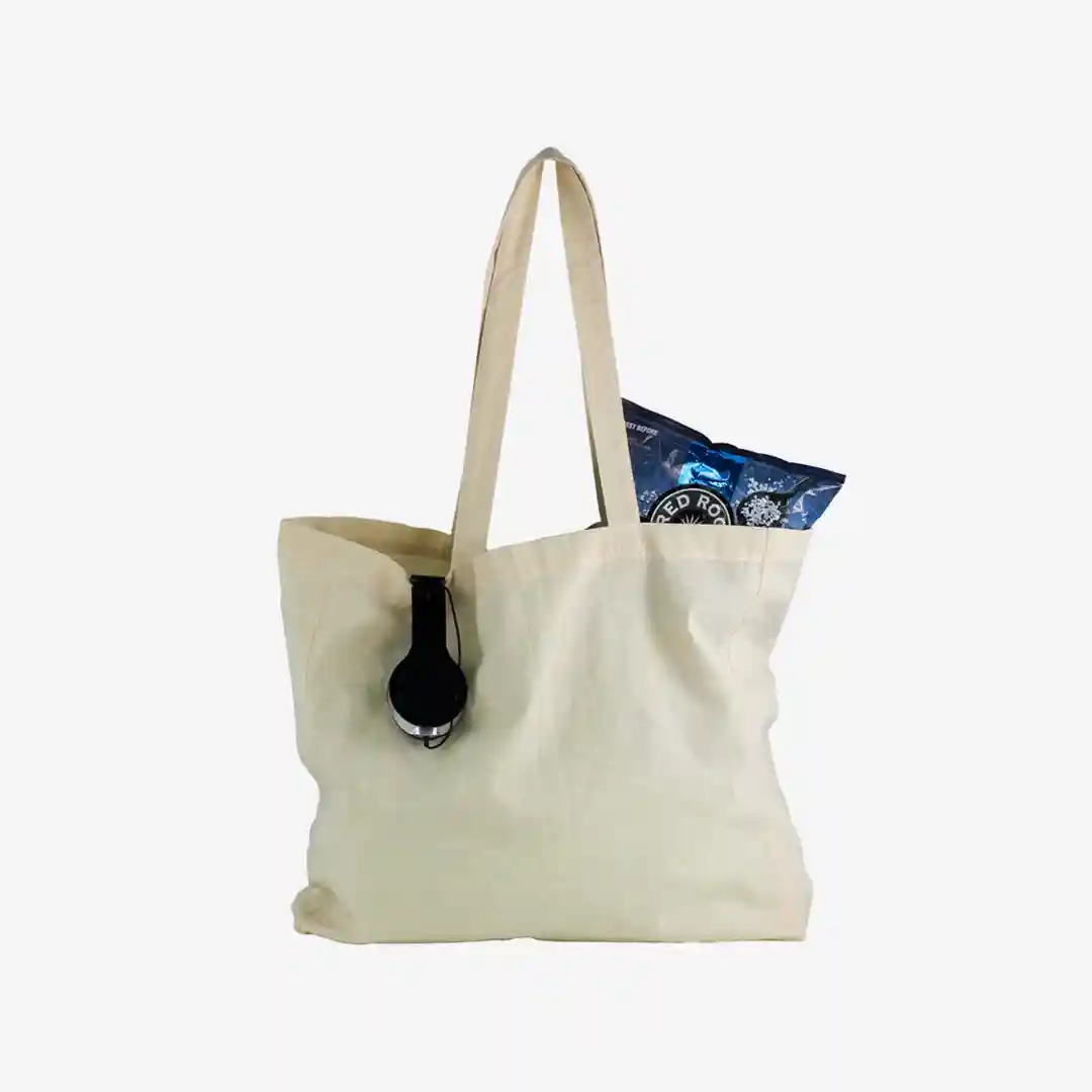 Person using a branded tote bag in a city shopping district