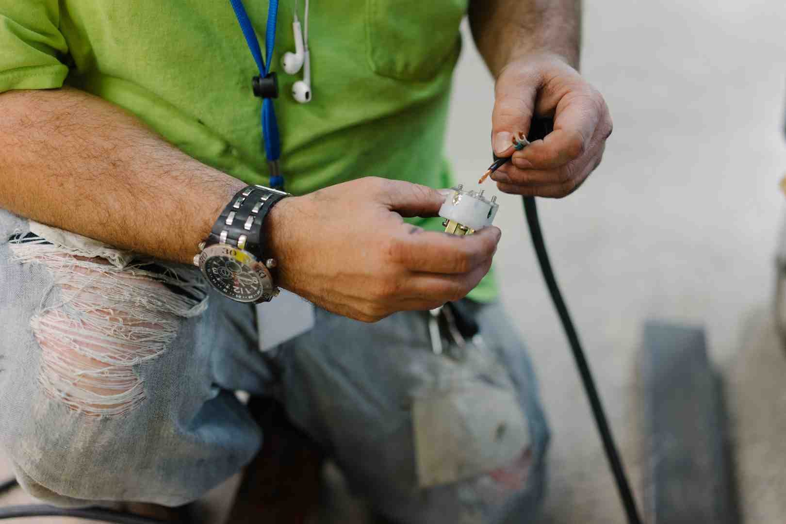 Grounded Solutions electrician disconnecting wires - changing a light fixture