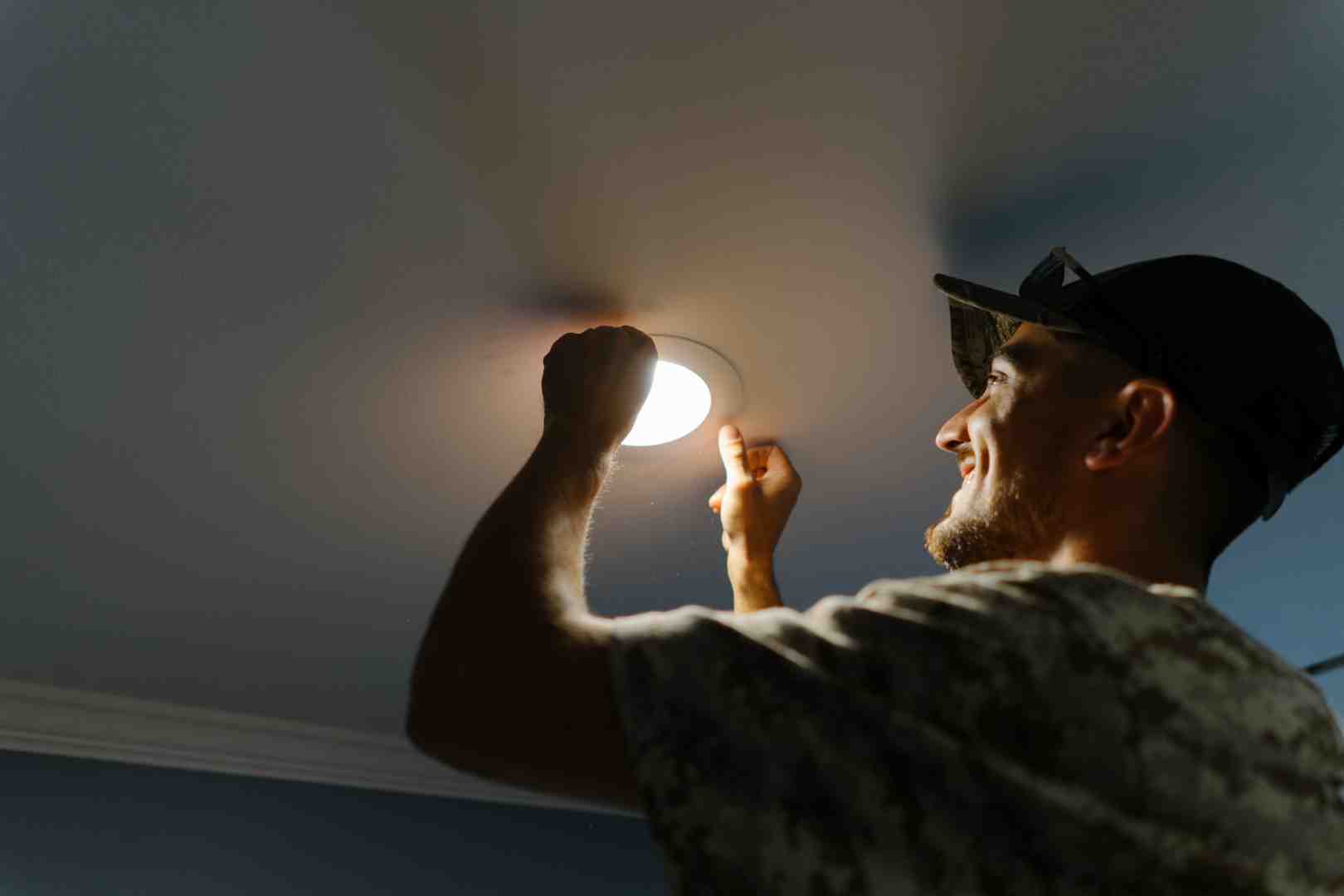 An electrician working on commercial lighting in a retail space - Commercial Electrician Carmel