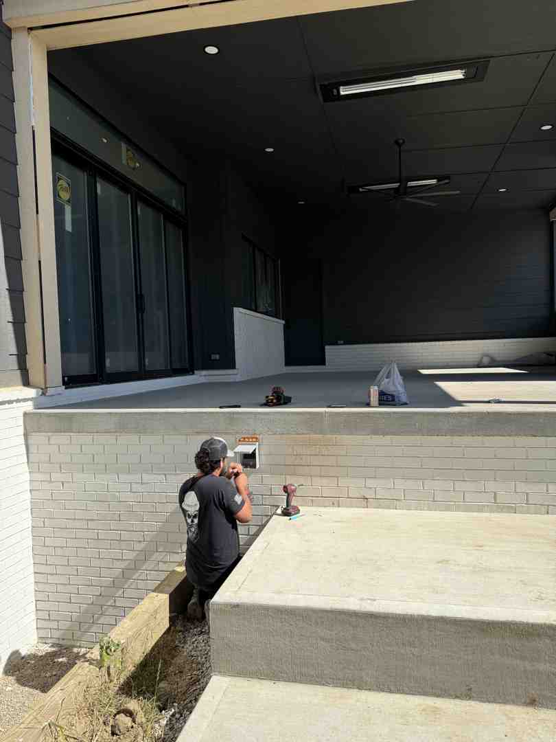 electrician professionally installing outdoor light fixture - waterproof outdoor lights for bargersville