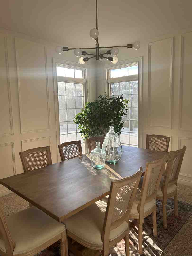 large, artistic chandelier over a dining table in a Southport home - decorative lighting trends