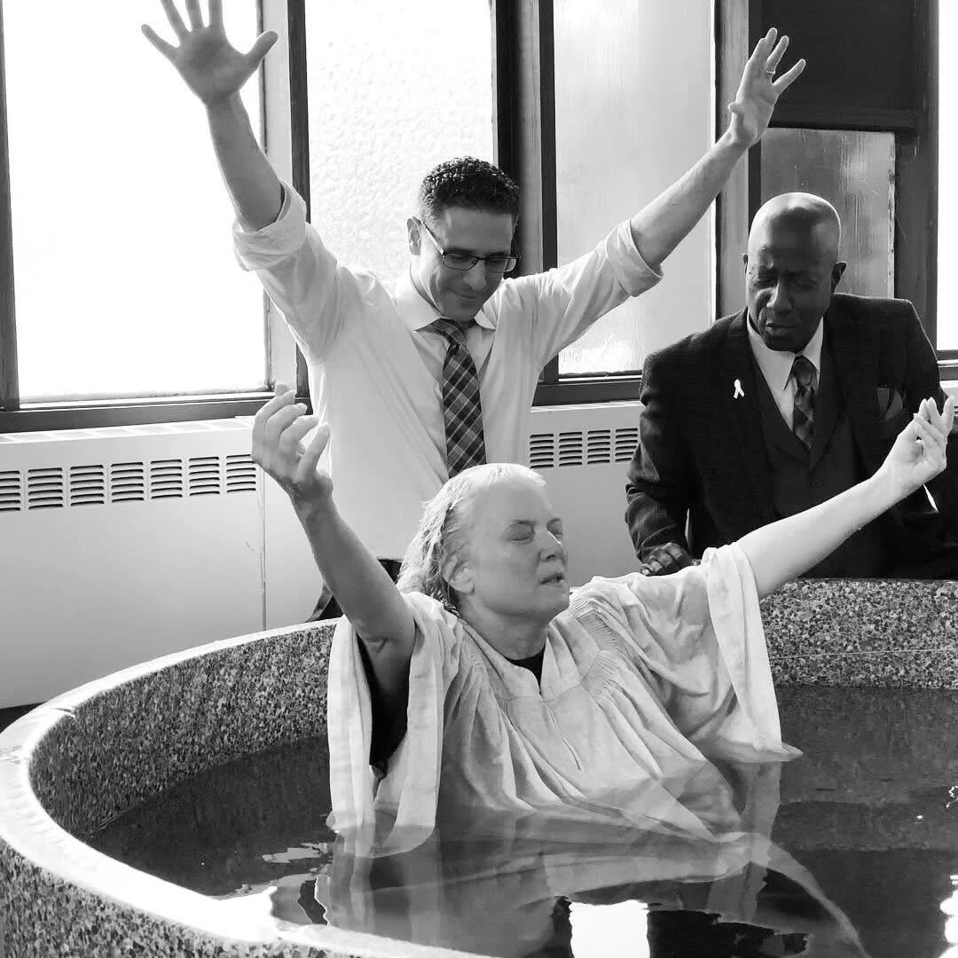 A joyful, Spirit-filled convert being baptized by full immersion in water in the name of Jesus Christ