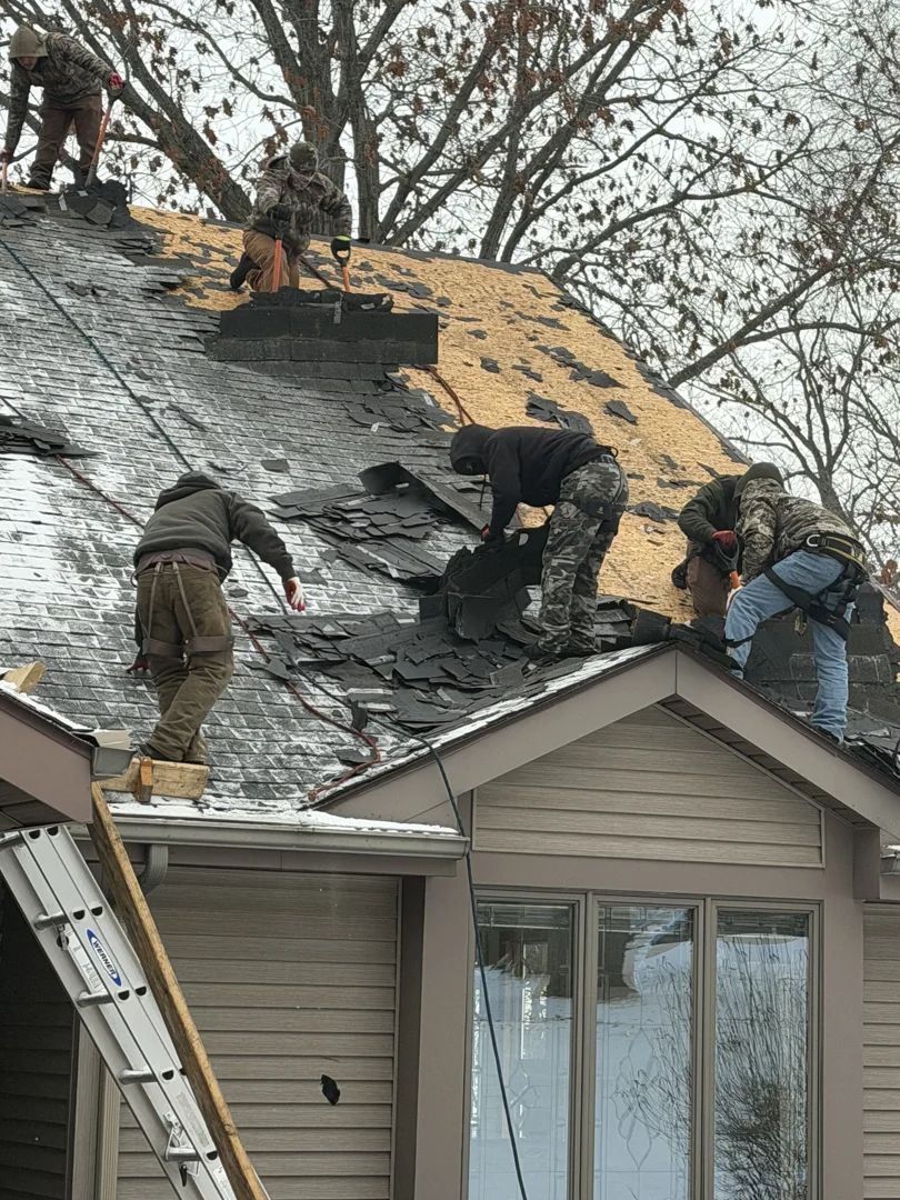 roofer tearing off old shingles and inspecting wood decking roofer tearing off old shingles and inspecting wood decking