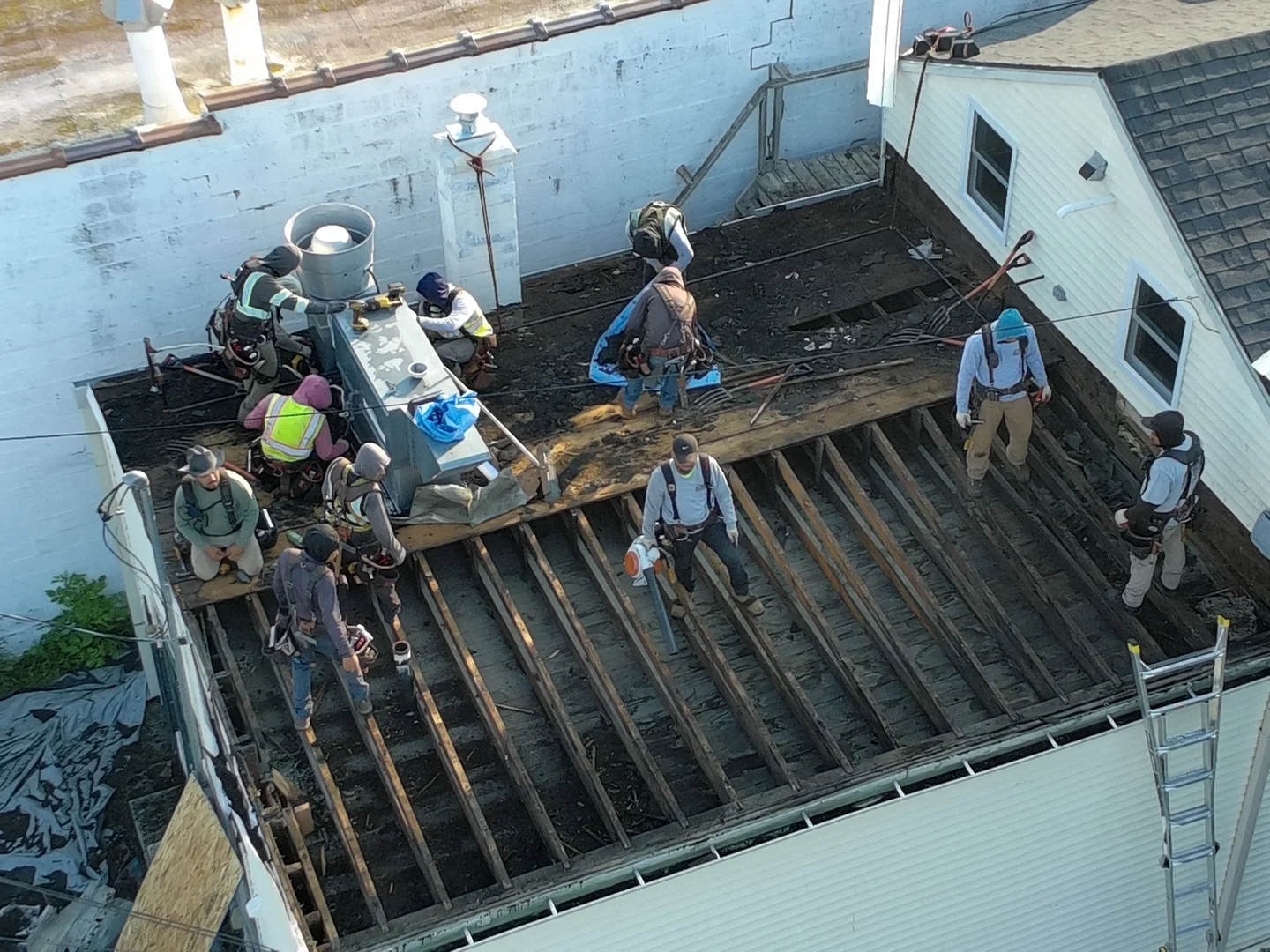 Polyiso insulation boards being installed on a roof deck - commercial roofing systems Polyiso insulation boards being installed on a roof deck - commercial roofing systems
