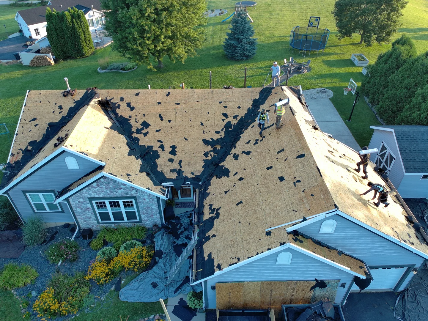 Professional crew performing a full tear-off of old roofing materials Professional crew performing a full tear-off of old roofing materials