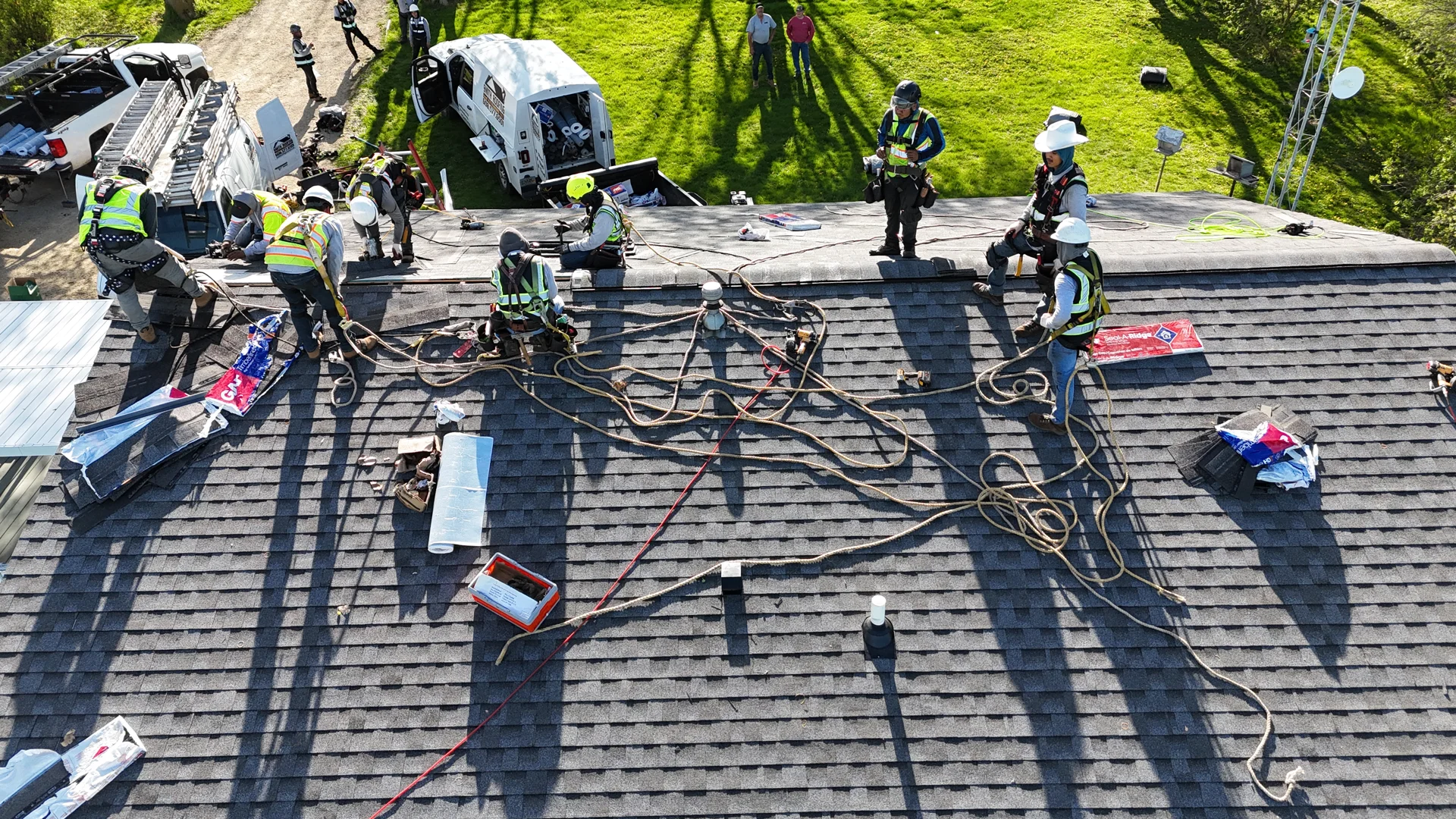 Applying asphalt wet patch cement to a damaged roof seam with a trowel Applying asphalt wet patch cement to a damaged roof seam with a trowel