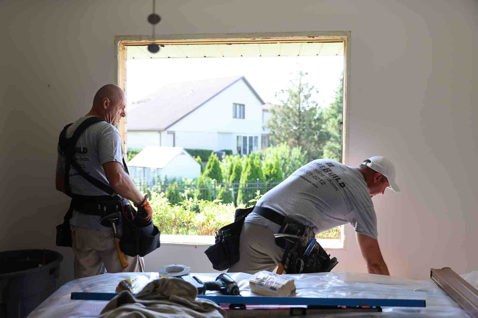 Detailed view of a professional window installation showing flashing tape and shingle-lap weather barrier integration