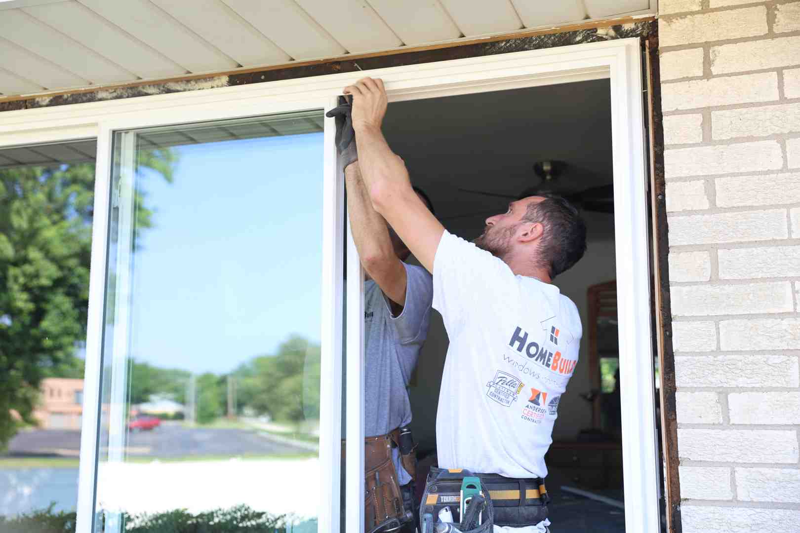 professional installer measuring a door frame - cost to replace exterior french doors