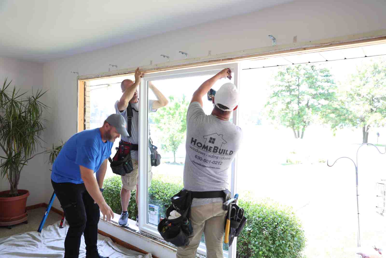 Professional installers fitting a new window - Arlington Heights window replacement