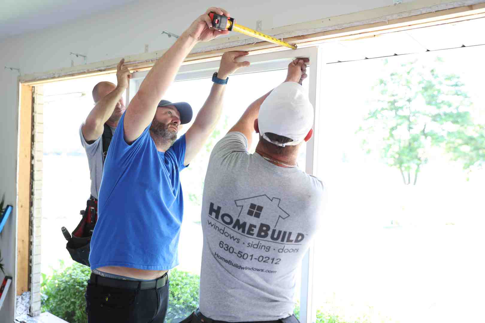 expert measuring a door frame for a storm door - professional storm door experts