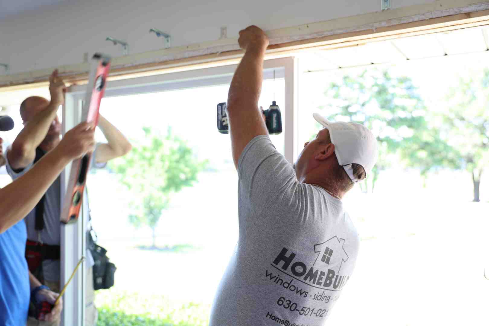 Tools required for storm door installation including a drill, level, measuring tape, and hacksaw - cost to install new storm door