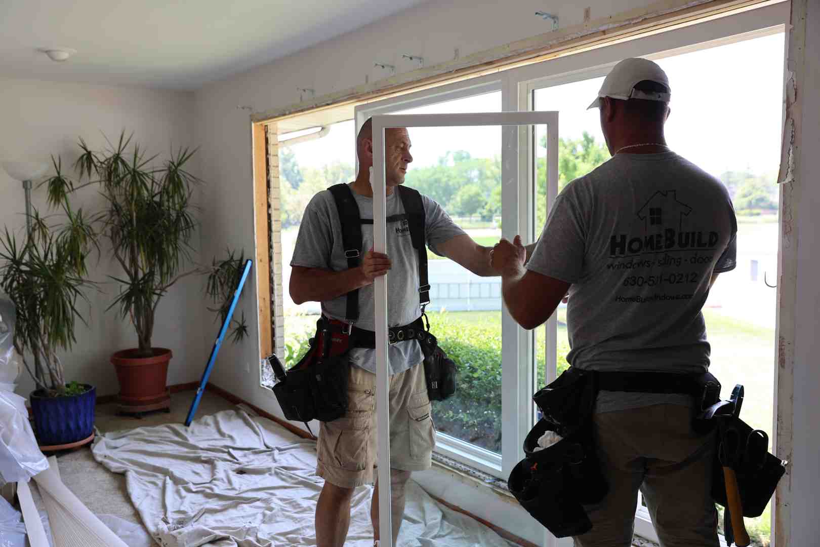 Standard window replacement being performed by professional installers - how much does labor cost to install windows