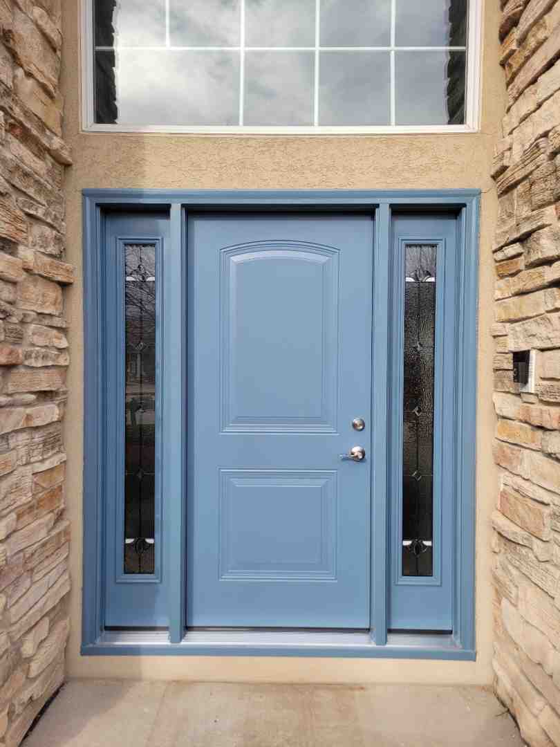 grand entryway with a front door featuring sidelights and a transom window - replacement doors exterior cost