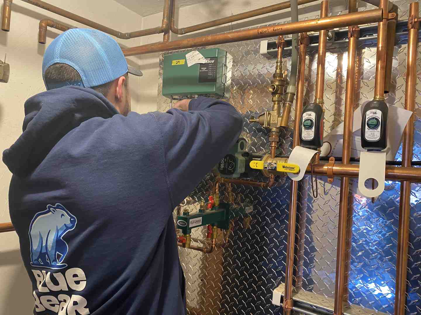 technician inspecting heating pipes - boiler repair best in natick, ma