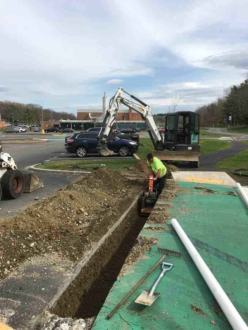 Professional sprinkler system installation showing trenching and pipe laying - professional sprinkler system installation