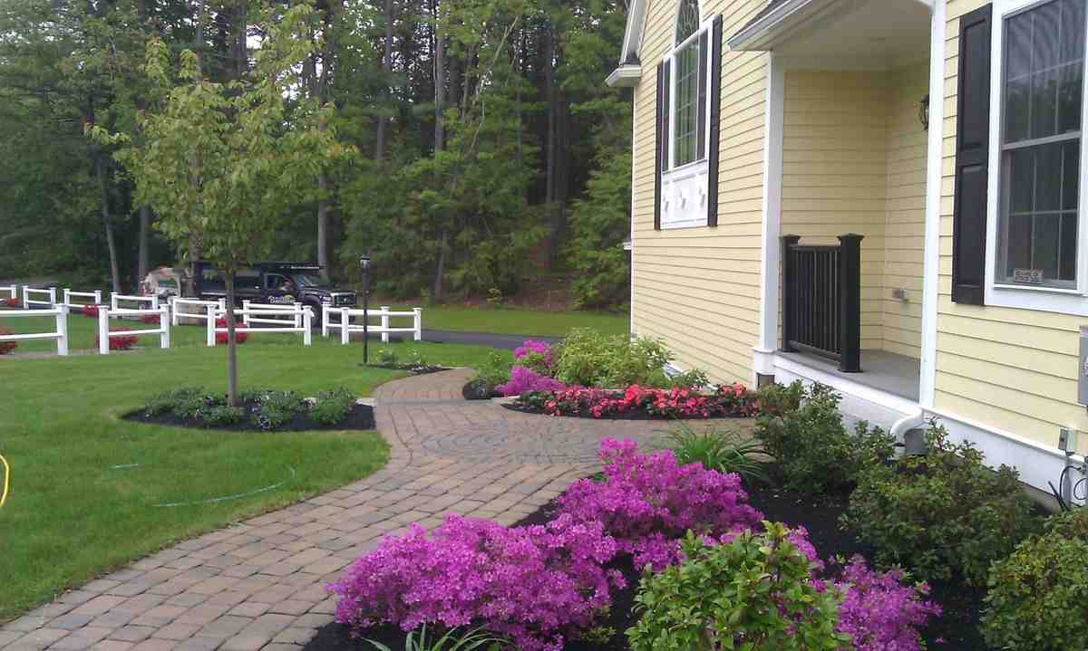 A meticulously maintained flower bed showcasing a thick, even layer of cedar mulch, completely free of weeds and enhancing the vibrant colors of the blooming flowers. - cedar mulch for flower beds