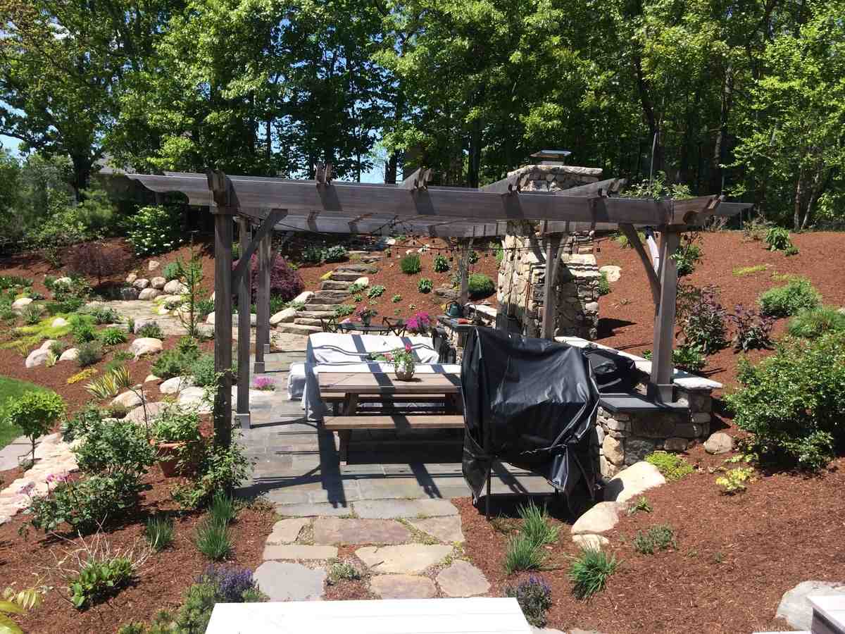 outdoor living space with fire pit and comfortable seating - landscape design methuen ma