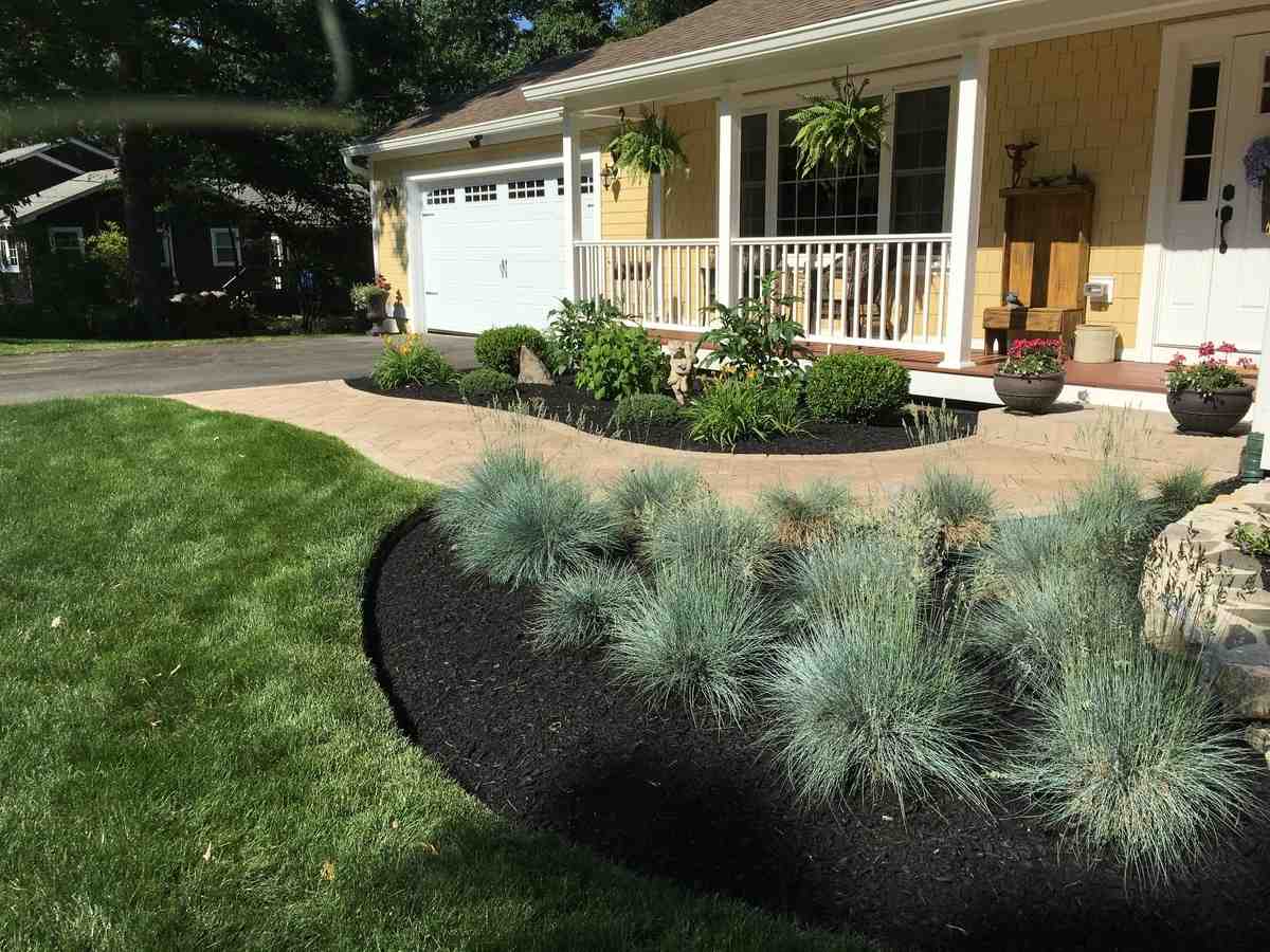 beautiful home garden with flowering plants and manicured lawn - commercial and residential landscaping