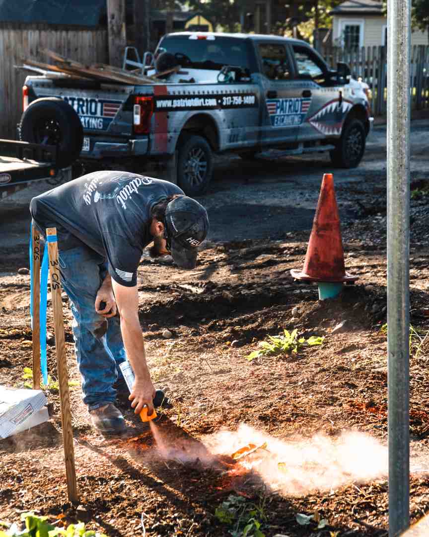Utility flags marking gas and water lines in a yard - dig a trench for drainage Utility flags marking gas and water lines in a yard - dig a trench for drainage
